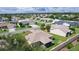 Aerial shot showcases the property with a screened patio and surrounding neighborhood at 2369 Five Forks Trl, The Villages, FL 32162
