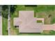 This aerial shot showcases a meticulously maintained roof and lush green lawn, demonstrating excellent curb appeal at 2369 Five Forks Trl, The Villages, FL 32162