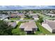 Aerial shot showcases the property with a screened patio and surrounding neighborhood at 2369 Five Forks Trl, The Villages, FL 32162