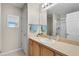 Bathroom featuring a single sink vanity with a mirror and shower at 2369 Five Forks Trl, The Villages, FL 32162