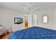 Bright bedroom features a ceiling fan, a window, and dresser with television at 2369 Five Forks Trl, The Villages, FL 32162