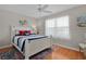 Charming bedroom with a white wooden bed frame and natural light from the window at 2369 Five Forks Trl, The Villages, FL 32162