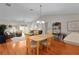 Open-concept living and dining area featuring hardwood floors and lots of natural light at 2369 Five Forks Trl, The Villages, FL 32162