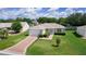 Charming single-story home featuring a well-manicured lawn and attached one car garage at 2369 Five Forks Trl, The Villages, FL 32162