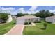 Charming single-story home featuring a well-manicured lawn and attached one car garage at 2369 Five Forks Trl, The Villages, FL 32162