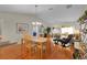 Beautiful open-concept living room featuring wood floors, vaulted ceilings, and sliding glass doors at 2369 Five Forks Trl, The Villages, FL 32162