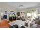 Comfortable living room featuring vaulted ceilings, access to the lanai, and a view of the TV and dining area at 2369 Five Forks Trl, The Villages, FL 32162