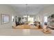 Open-concept living room featuring a dining area, and sliding glass doors to the outside patio at 2369 Five Forks Trl, The Villages, FL 32162