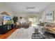 Inviting living room featuring cozy seating, modern entertainment center, and access to the screened lanai at 2369 Five Forks Trl, The Villages, FL 32162