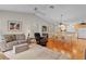 Open-concept living room and dining area with modern furnishings and hardwood floors at 2369 Five Forks Trl, The Villages, FL 32162