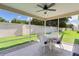 Enclosed screened in lanai with a white table and chairs, overlooking the backyard at 2369 Five Forks Trl, The Villages, FL 32162