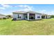 Expansive green backyard with a covered patio, perfect for outdoor relaxation and activities at 23707 Companero Dr, Sorrento, FL 32776