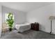 Simple bedroom with carpeted floors, dresser, chair and a large window with natural light at 23707 Companero Dr, Sorrento, FL 32776