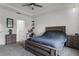 Bedroom with tray ceiling, ceiling fan, and an adjacent doorway and study nook at 23707 Companero Dr, Sorrento, FL 32776