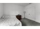 Neutral bedroom with a double closet, side table, lamp and carpeted floors at 23707 Companero Dr, Sorrento, FL 32776