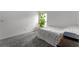 This bedroom features neutral carpeting, a window for natural light, and a minimalist aesthetic at 23707 Companero Dr, Sorrento, FL 32776