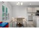 Cozy breakfast nook with a view to the back yard, adjacent to the kitchen, and chandelier lighting at 23707 Companero Dr, Sorrento, FL 32776
