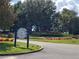 Community entrance to Sorrento Springs featuring an attractive stone sign and landscaping at 23707 Companero Dr, Sorrento, FL 32776