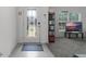 Bright entryway featuring a decorative glass door and gray carpet in the living room at 23707 Companero Dr, Sorrento, FL 32776