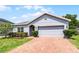 Beautiful one story home with manicured lawn, mature landscaping and brick driveway at 23707 Companero Dr, Sorrento, FL 32776