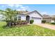 Charming single-story home features a manicured lawn, tidy landscaping, and a two-car garage at 23707 Companero Dr, Sorrento, FL 32776
