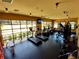 A variety of exercise equipment and natural light create an appealing workout environment in the community gym at 23707 Companero Dr, Sorrento, FL 32776