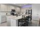 Updated kitchen featuring quartz countertops, stainless steel appliances, and a large island with bar seating at 23707 Companero Dr, Sorrento, FL 32776