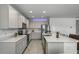 Well-appointed kitchen with white cabinets, quartz counters, and modern appliances, offering ample counter space at 23707 Companero Dr, Sorrento, FL 32776
