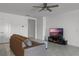 Comfortable living room featuring neutral paint, modern ceiling fan, and entertainment center at 23707 Companero Dr, Sorrento, FL 32776