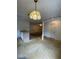 Open layout with older kitchen adjacent to a dining area, with tile floor and a retro light fixture at 2421 Centennial Blvd, Leesburg, FL 34748