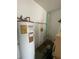 A utility room features a hot water heater, and a shelf for storage in this home at 2421 Centennial Blvd, Leesburg, FL 34748