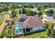 Gorgeous home featuring a screened pool, lush landscaping, and scenic waterfront views at 2457 Bar Harbor, Mount Dora, FL 32757
