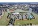 Aerial view of a community featuring a lake, pool, tennis courts, and clubhouse at 2457 Bar Harbor, Mount Dora, FL 32757