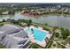 Aerial view showcases a stunning community pool, clubhouse, and beautiful lakefront homes at 2457 Bar Harbor, Mount Dora, FL 32757