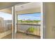 Balcony view of lake with fence and greenery surrounding peaceful waterfront at 2457 Bar Harbor, Mount Dora, FL 32757
