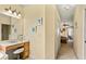 A bathroom featuring a vanity, mirror, and view into a bedroom at 2457 Bar Harbor, Mount Dora, FL 32757