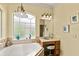 A bathroom featuring a bathtub, vanity, and decorative accents at 2457 Bar Harbor, Mount Dora, FL 32757