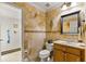 Beautiful bathroom featuring tile walls, stylish vanity and fixtures, and a classic toilet design at 2457 Bar Harbor, Mount Dora, FL 32757