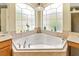 A bathtub with a large arched window providing natural light at 2457 Bar Harbor, Mount Dora, FL 32757