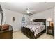 Cozy bedroom features a dark wood bed frame and seashell patterned quilt at 2457 Bar Harbor, Mount Dora, FL 32757