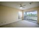 Inviting bedroom with neutral color palette, ceiling fan, and sliding glass doors leading to balcony with lake views at 2457 Bar Harbor, Mount Dora, FL 32757