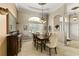 Formal dining room featuring a large window, chandelier, and elegant decor at 2457 Bar Harbor, Mount Dora, FL 32757