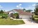 Well-maintained home with a two-car garage, beautiful landscaping, and a lovely pathway to the front door at 2457 Bar Harbor, Mount Dora, FL 32757