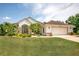 Charming one-story home featuring a well-manicured lawn and attached two-car garage at 2457 Bar Harbor, Mount Dora, FL 32757