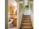 View of hallway showcasing bathroom, stairs, and neutral paint with classic white trim at 2457 Bar Harbor, Mount Dora, FL 32757