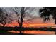 Waterfront sunset view of orange skies with lake reflecting the warm glow at 2457 Bar Harbor, Mount Dora, FL 32757