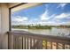 Expansive view of lake from balcony showing lush greenery, blue sky, and serene waterfront at 2457 Bar Harbor, Mount Dora, FL 32757