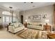 Elegant living room with classic decor, comfortable sofas, and a view of the front door at 2457 Bar Harbor, Mount Dora, FL 32757