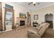 Comfortable living room featuring a stone fireplace, media, and plush seating at 2457 Bar Harbor, Mount Dora, FL 32757