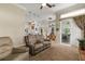 Another view of living room with fireplace, furnishings, and access to other areas at 2457 Bar Harbor, Mount Dora, FL 32757